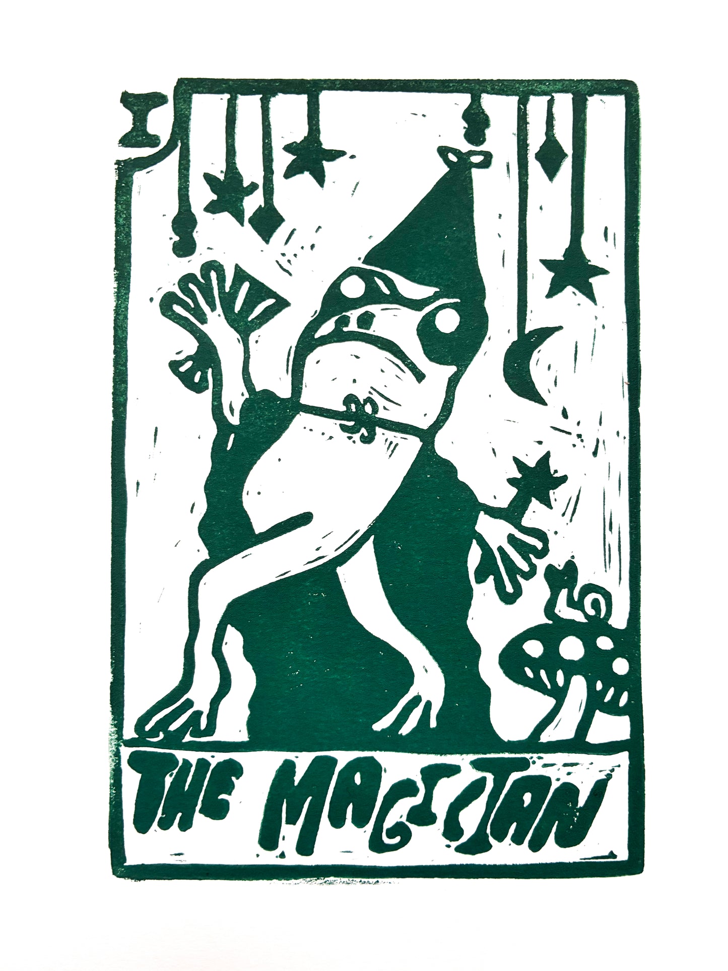 Green Tarot card print of a stylized frog wearing a cape on a white background with 'The Magician' text