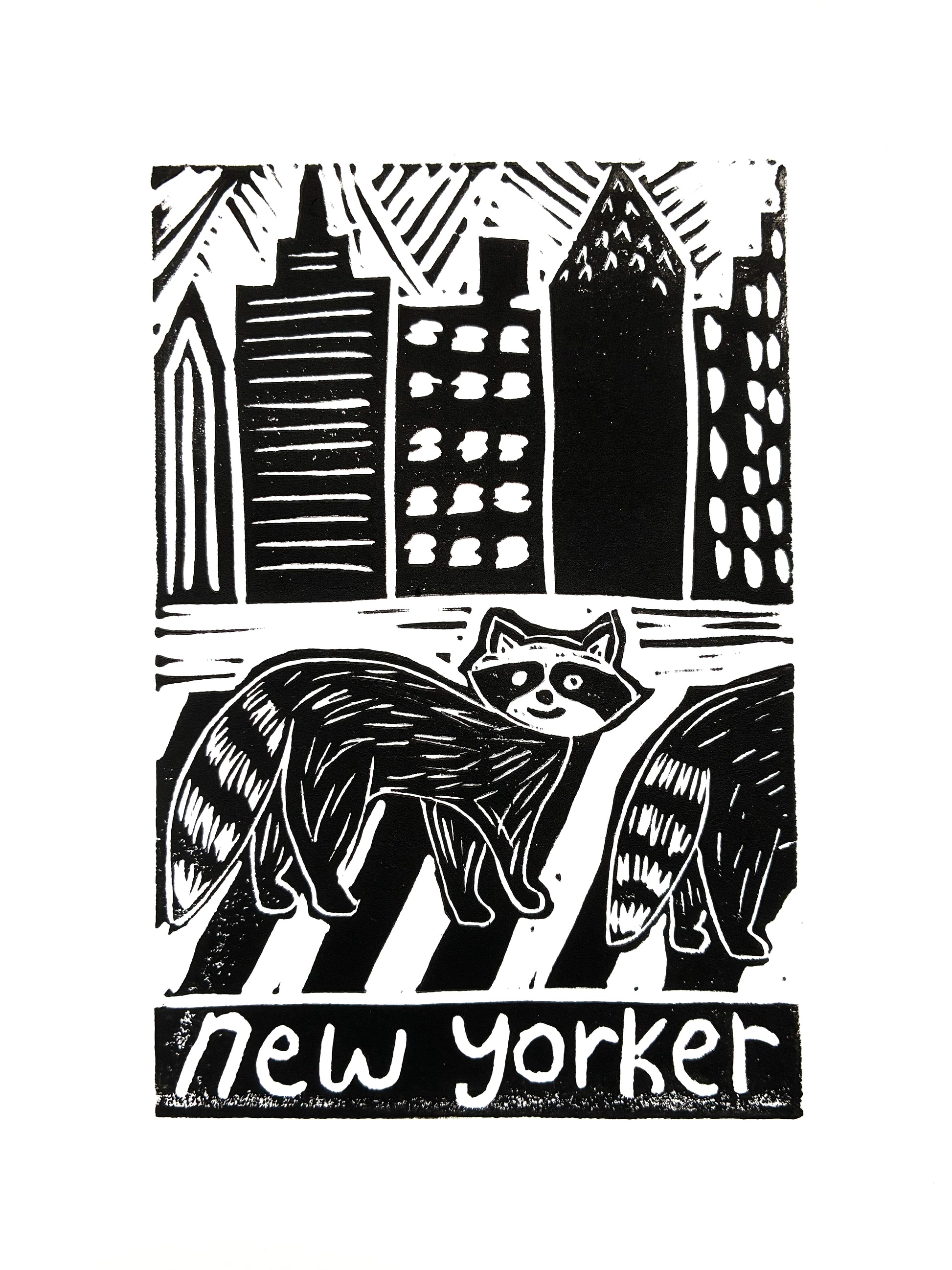 Print of two raccoons crossing a street with city skyline in the background, with 'new yorker' text.
