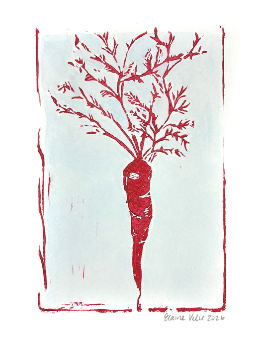 A minimalist art print featuring a stylized red carrot with leafy branches on a pale blue rectangular field, bordered by a rough red frame, with a white margin around the print and a small signature at the bottom right.
