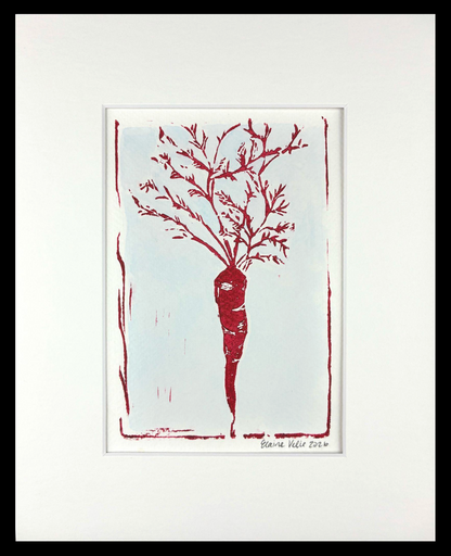 A framed art print featuring a minimalist red drawing of a carrot with leafy roots on a white background, surrounded by a wide white mat and a black frame.