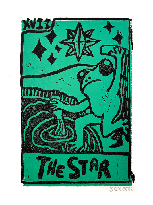 A stylized tarot card print titled "The Star" with a bright teal-green background and bold black linework and text. The card shows a star, diamond shapes, a seated figure, and the year 2026 signed at the bottom right, photographed against a white background.